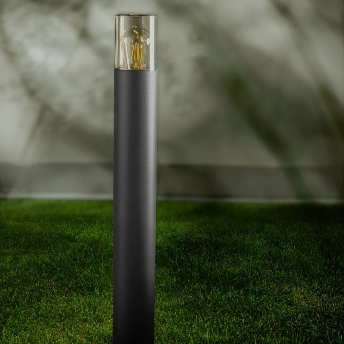 This post light is featured with a smoky diffuser, dark grey finish and ideal for outdoor use. Measuring around 50cm in height, this elegantly designed pillar light blends with either modern or traditional houses. The extended height of this product (compared to our medium dark grey post light) allows it to show off its features better. 