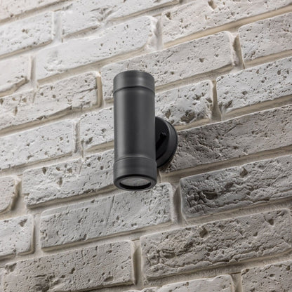 Our Valentine Dark Grey outdoor wall mounted up and down cylinder outdoor light would look perfect in a modern or more traditional home design. Outside wall lights can provide atmospheric light in your garden, at the front door or on the terrace as well as a great security solution. It is designed for durability and longevity with its robust material producing a fully weatherproof and water resistant light fitting.  Use LED bulbs to make this light energy efficient and low cost to run.