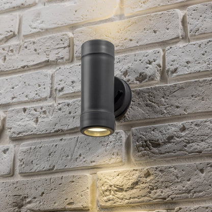 Our Valentine Dark Grey outdoor wall mounted up and down cylinder outdoor light would look perfect in a modern or more traditional home design. Outside wall lights can provide atmospheric light in your garden, at the front door or on the terrace as well as a great security solution. It is designed for durability and longevity with its robust material producing a fully weatherproof and water resistant light fitting.  Use LED bulbs to make this light energy efficient and low cost to run.