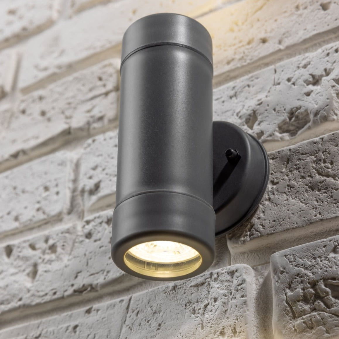 Our Valentine Dark Grey outdoor wall mounted up and down cylinder outdoor light would look perfect in a modern or more traditional home design. Outside wall lights can provide atmospheric light in your garden, at the front door or on the terrace as well as a great security solution. It is designed for durability and longevity with its robust material producing a fully weatherproof and water resistant light fitting.  Use LED bulbs to make this light energy efficient and low cost to run.