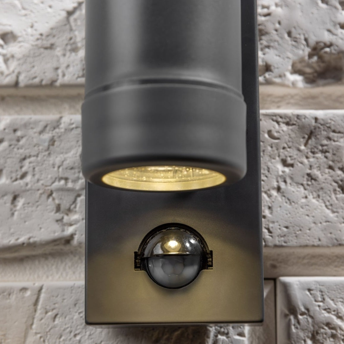 Our Valentine dark grey outdoor wall mounted up and down cylinder outdoor light with motion sensor would look perfect in a modern or more traditional home design. Outside wall lights can provide atmospheric light in your garden, at the front door or on the terrace as well as a great security solution. It is designed for durability and longevity with its robust material producing a fully weatherproof and water resistant light fitting.