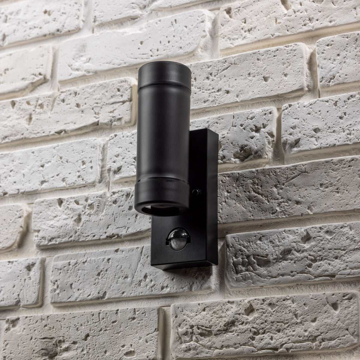 Our Valentine black outdoor wall mounted up and down cylinder outdoor light with motion sensor would look perfect in a modern or more traditional home design. Outside wall lights can provide atmospheric light in your garden, at the front door or on the terrace as well as a great security solution.