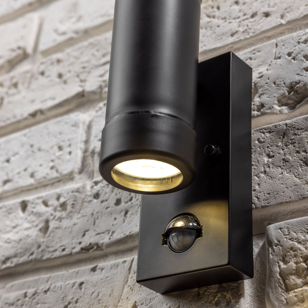 Our Valentine black outdoor wall mounted up and down cylinder outdoor light with motion sensor would look perfect in a modern or more traditional home design. Outside wall lights can provide atmospheric light in your garden, at the front door or on the terrace as well as a great security solution.