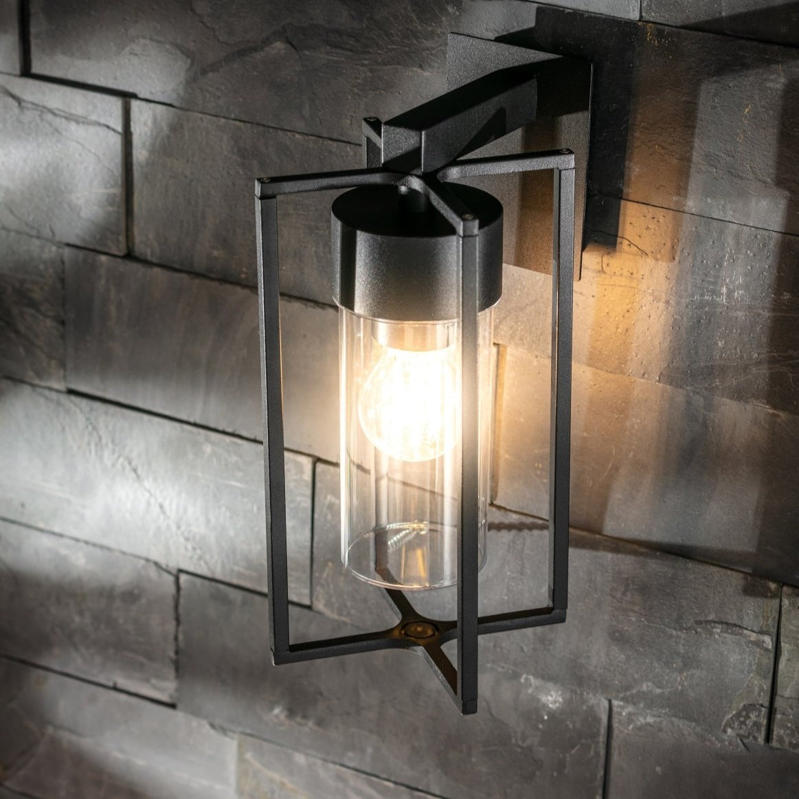 If you’re looking for a modern take on a traditional outdoor wall light, this black lantern wall light with clear diffuser is perfect for adding style and protection for your home. This classic design with a contemporary twist, styled with a metal lantern shape and fitted with a cylinder diffuser that allows the light to shine effectively