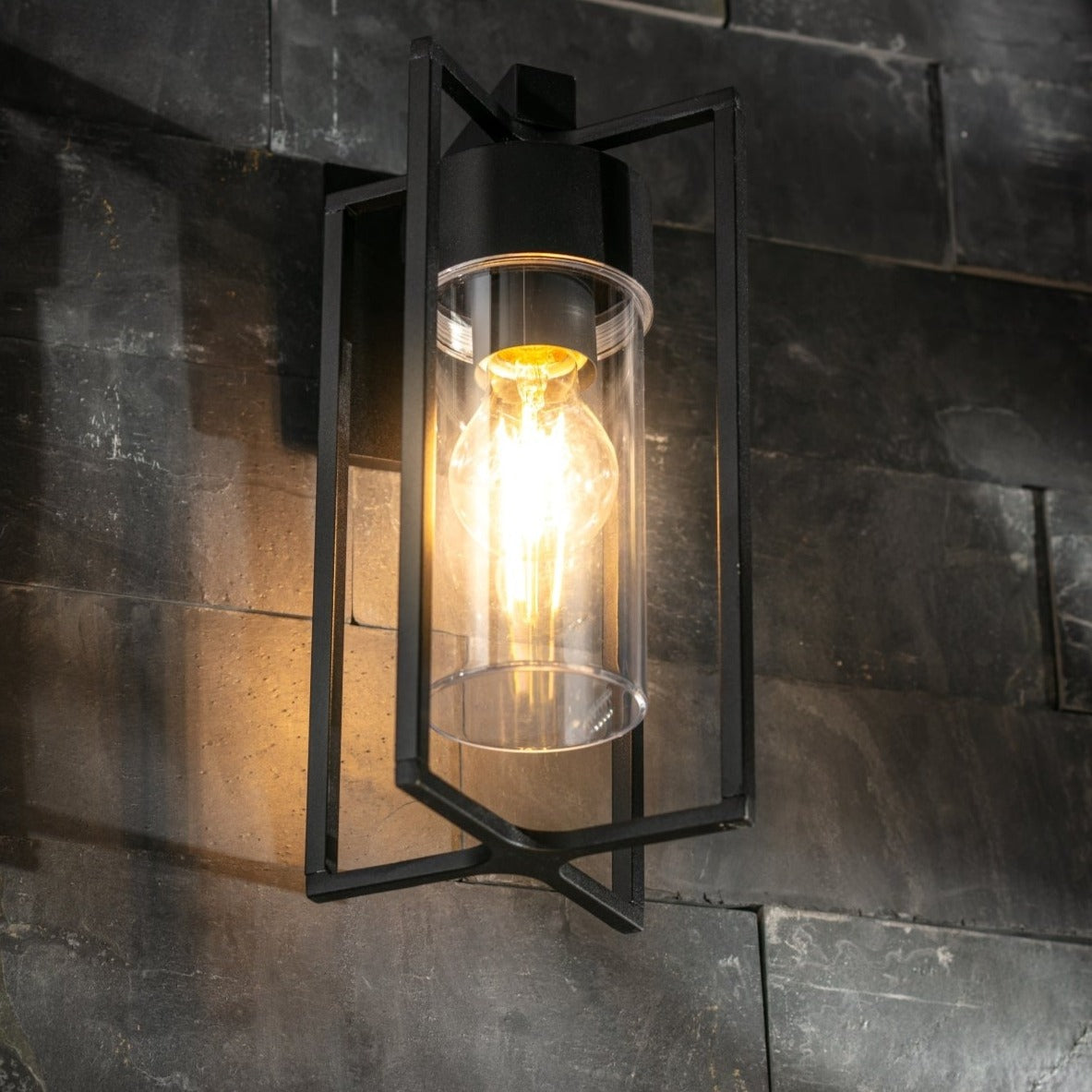 If you’re looking for a modern take on a traditional outdoor wall light, this black lantern wall light with clear diffuser is perfect for adding style and protection for your home. This classic design with a contemporary twist, styled with a metal lantern shape and fitted with a cylinder diffuser that allows the light to shine effectively