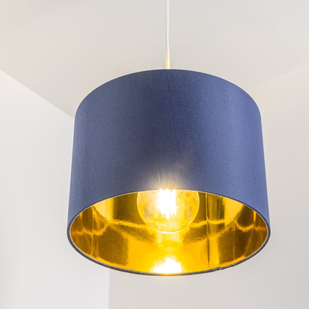 Our Lupo luxury cotton shade is sophisticated in appearance and we have designed the shade to suit a range of interiors. Easy to fit, it’s crafted from high-quality cotton on the outer and has a reflective gold metallic inner. It's made to fit both a ceiling light or lamp base.