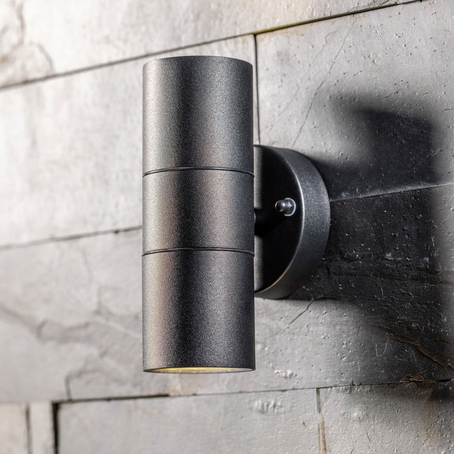  Our Leon outdoor up and down outdoor wall light is modern and stylish in its appearance.  It comes in a cylinder design mounted on a circular back plate and complete with clear glass diffusers. It is designed for durability and longevity with its robust material producing a fully weatherproof and water resistant light fitting