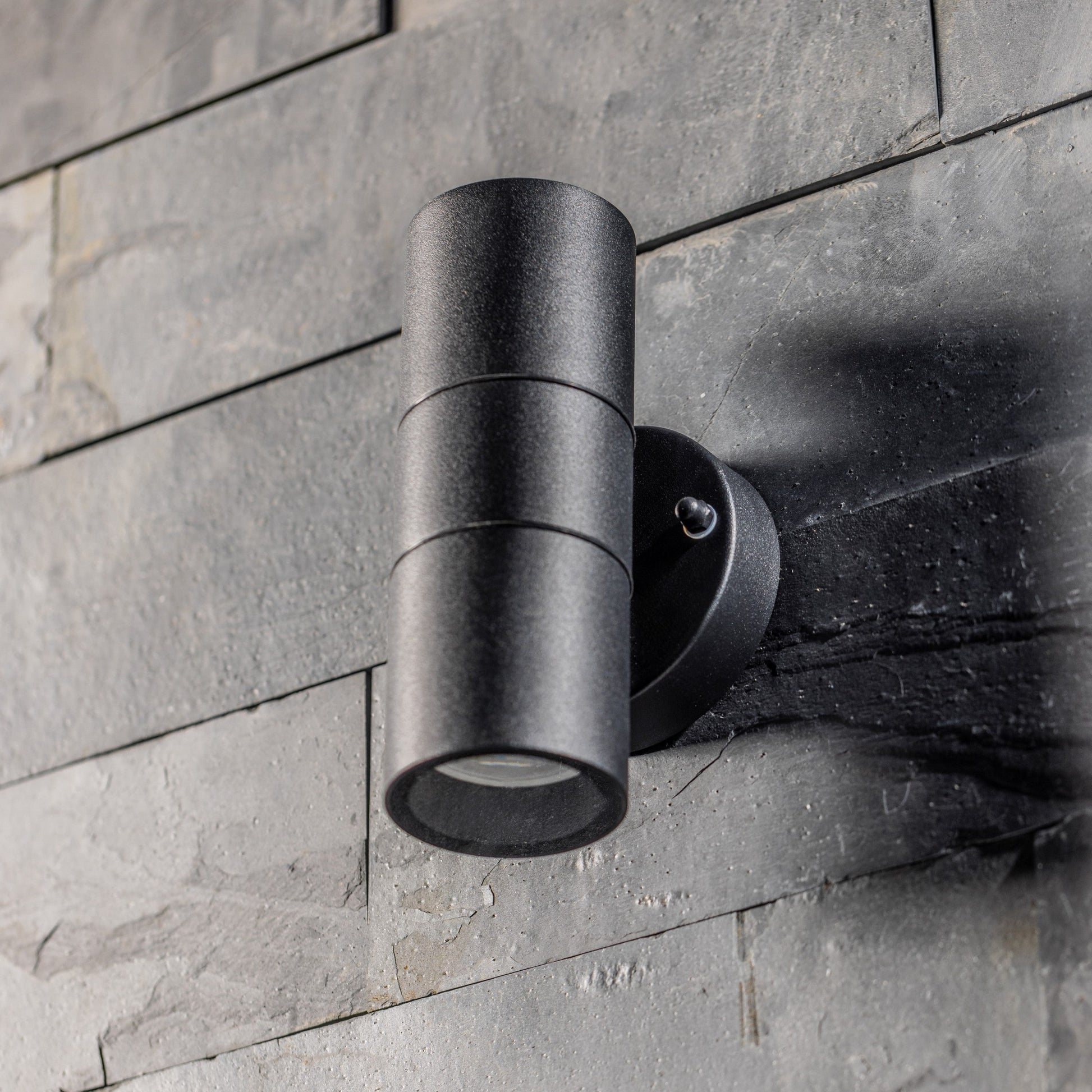  Our Leon outdoor up and down outdoor wall light is modern and stylish in its appearance.  It comes in a cylinder design mounted on a circular back plate and complete with clear glass diffusers. It is designed for durability and longevity with its robust material producing a fully weatherproof and water resistant light fitting